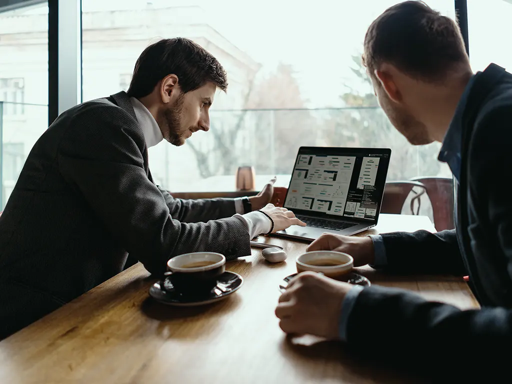 two-young-businessman-having-successful-meeting-restaurant